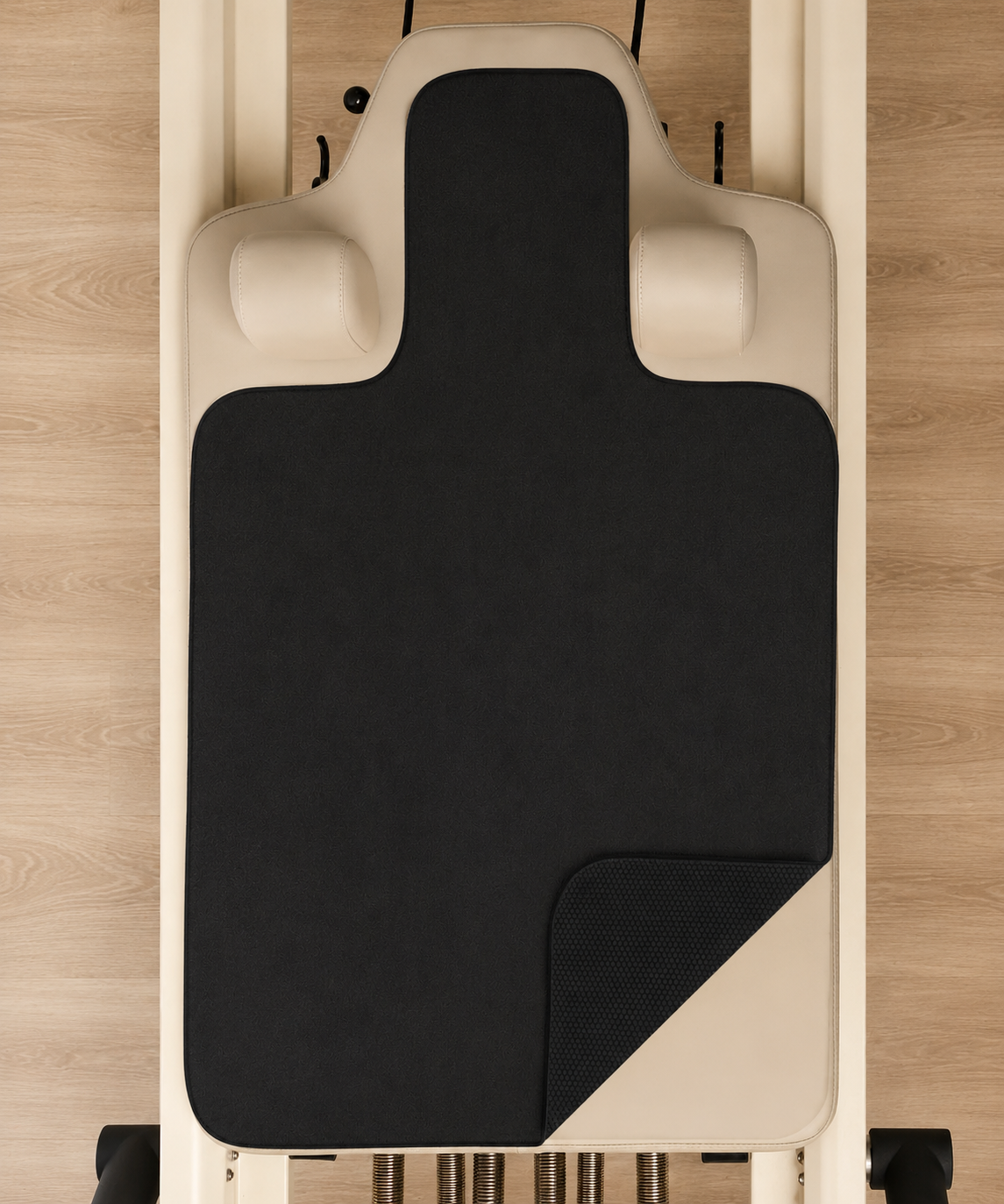 Custom branded reformer grip towel on a Pilates reformer carriage