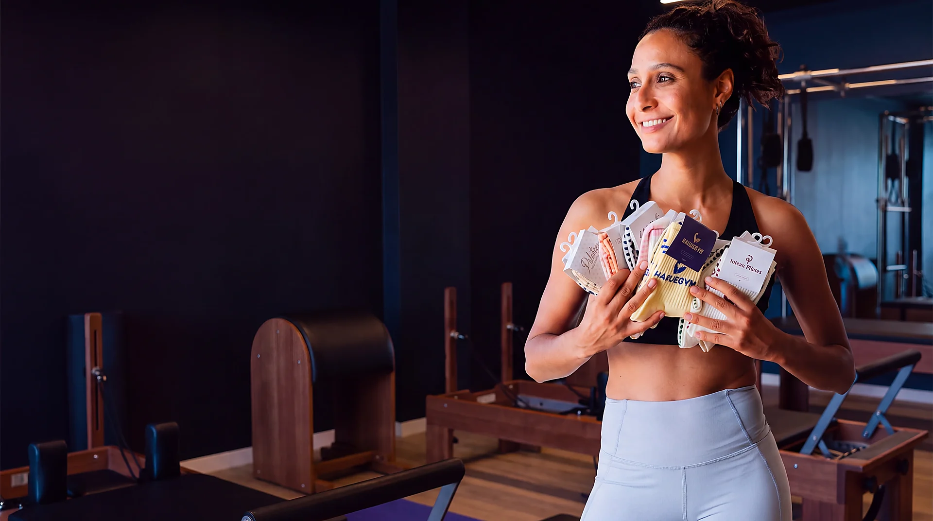 Pilates studio owner holding custom branded grip socks
