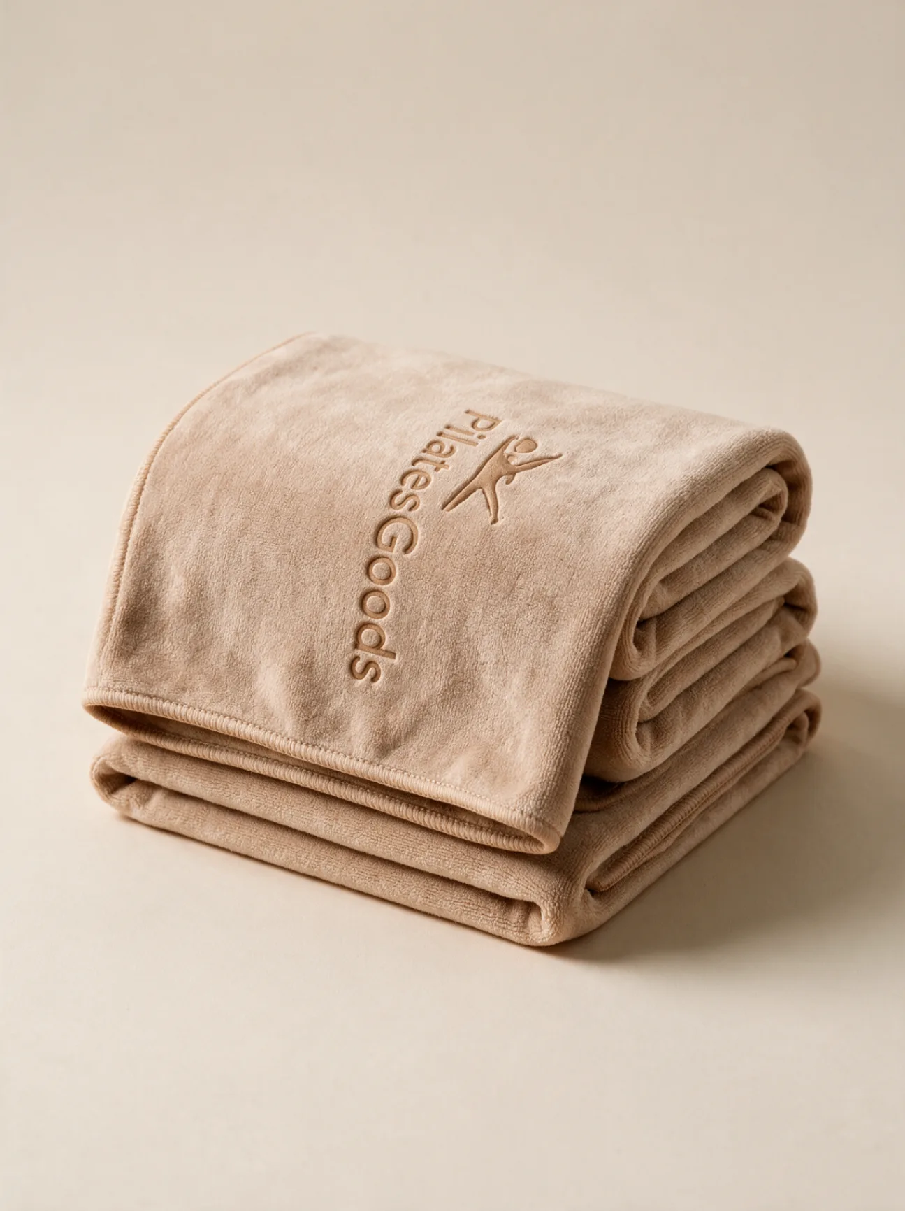 Custom branded Pilates microfiber towel in soft beige with embossed Pilates Goods logo, available in 20+ colors