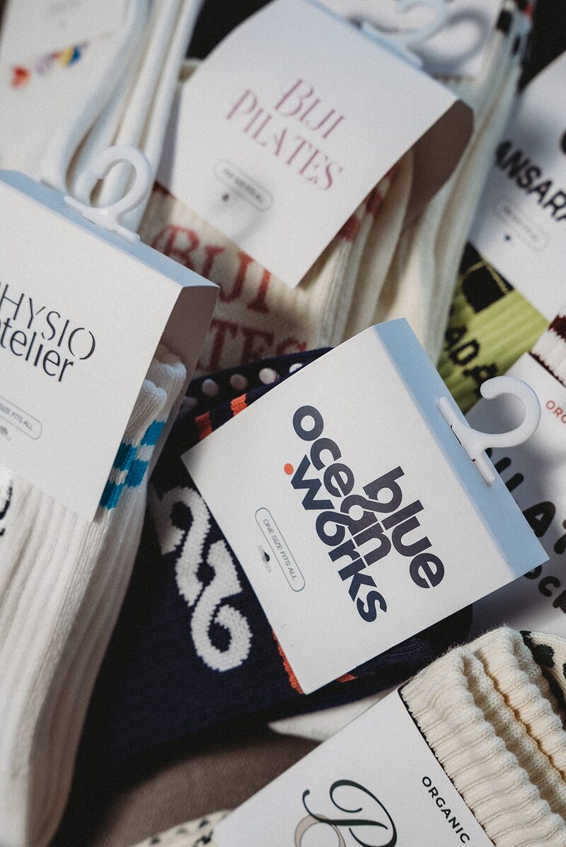 Custom branded Pilates grip socks in studio packaging