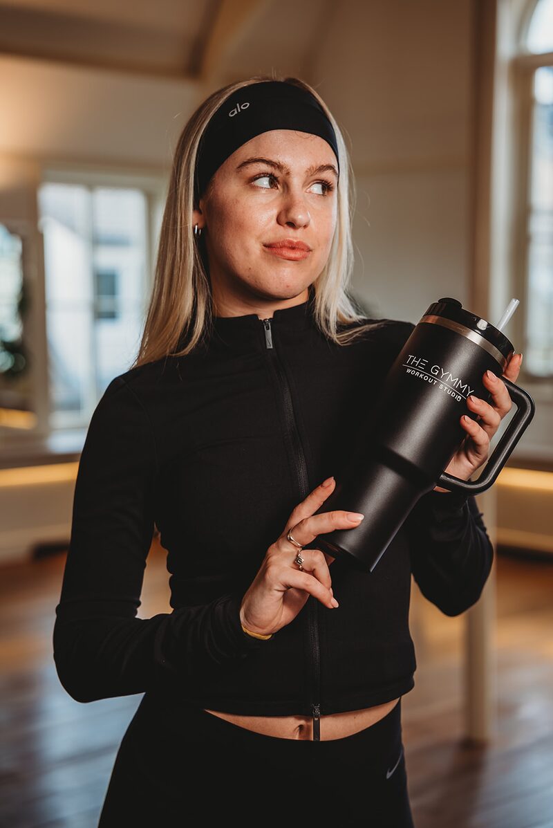 Studio owner holding a custom branded mega cup